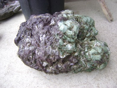 a purple and green rock, great for ponds, gardens, or decoration